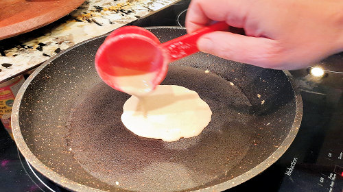{image: Shaping the crepe - pouring the batter}