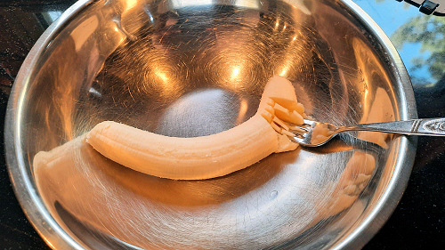 {image: Mashing the banana}