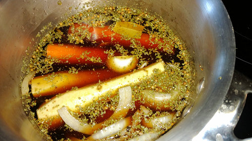 {image: Simmering carrot dogs}